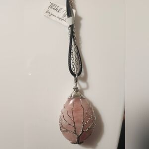Wire-wrapped rose quartz teardrop pendant with a tree of life design.
